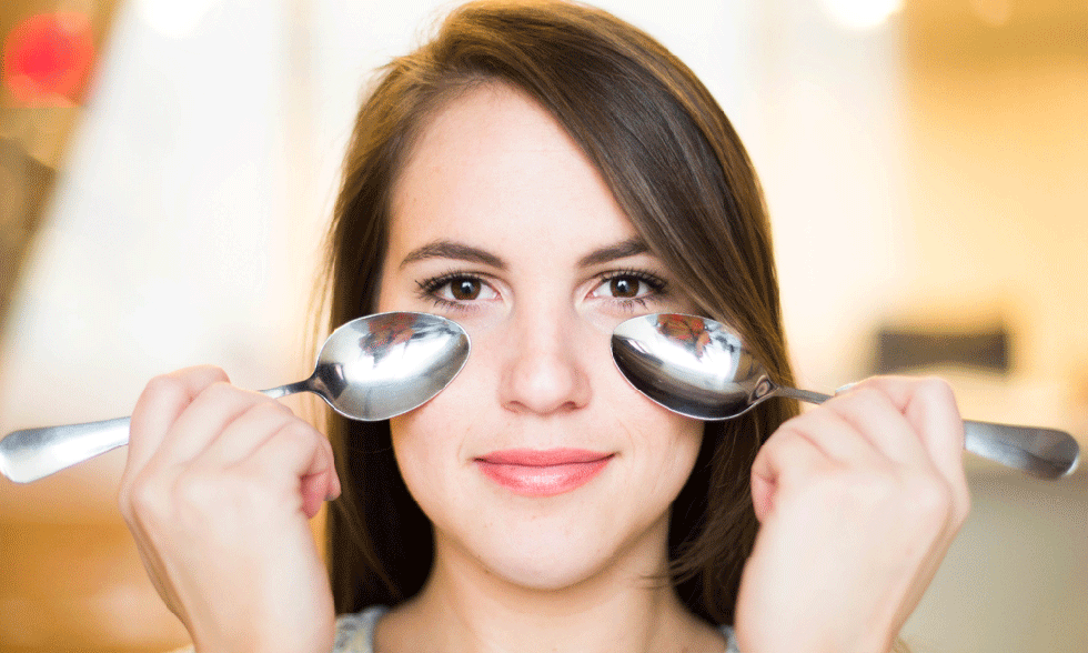 spoon against bags under eyes
