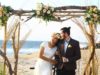 bride wears flower crown at bohemian beach wedding