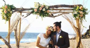 bride wears flower crown at bohemian beach wedding